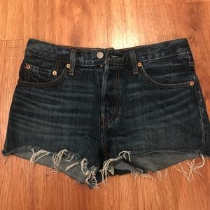 Dark distressed Levi’s denim shorts, size 28.